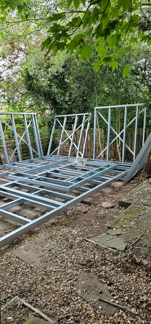 Light gauge steel wall panels being erected around a floor frame