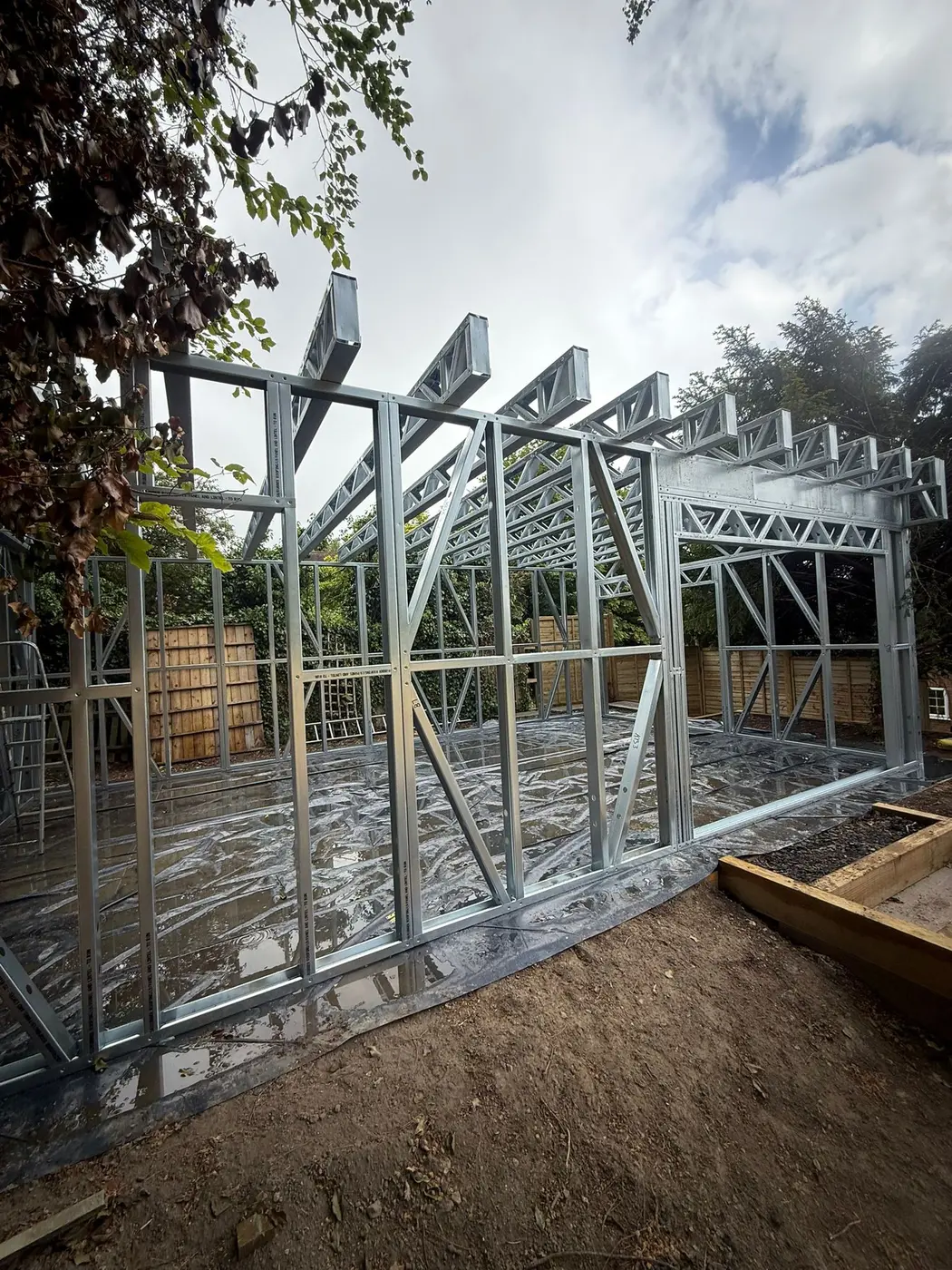 Large multi-bay Forti Nova light gauge steel frame with roof trusses and structural openings during erection